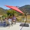 11ft Round Curved Offset Hanging Umbrella with Base-Red on the terrace