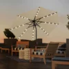 9ft Round Tilt Patio Umbrella with Solar LED Light-Beige on the terrace