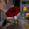 9ft Round Tilt Patio Umbrella with Solar LED Light at night at the front porch