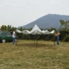 A couple opening the 10 x 10ft Square Pop Up Canopy Tent- White on the lawn