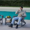A man drinking his coffee on the Modern Adirondack Rocking Chair-Dark Gray
