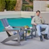 A man relaxing on the Modern Adirondack Rocking Chair-Drak Gray on the terrace
