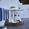 Olefin 10ft Round Auto Tilt Patio Umbrella-Creamy White on the terrace