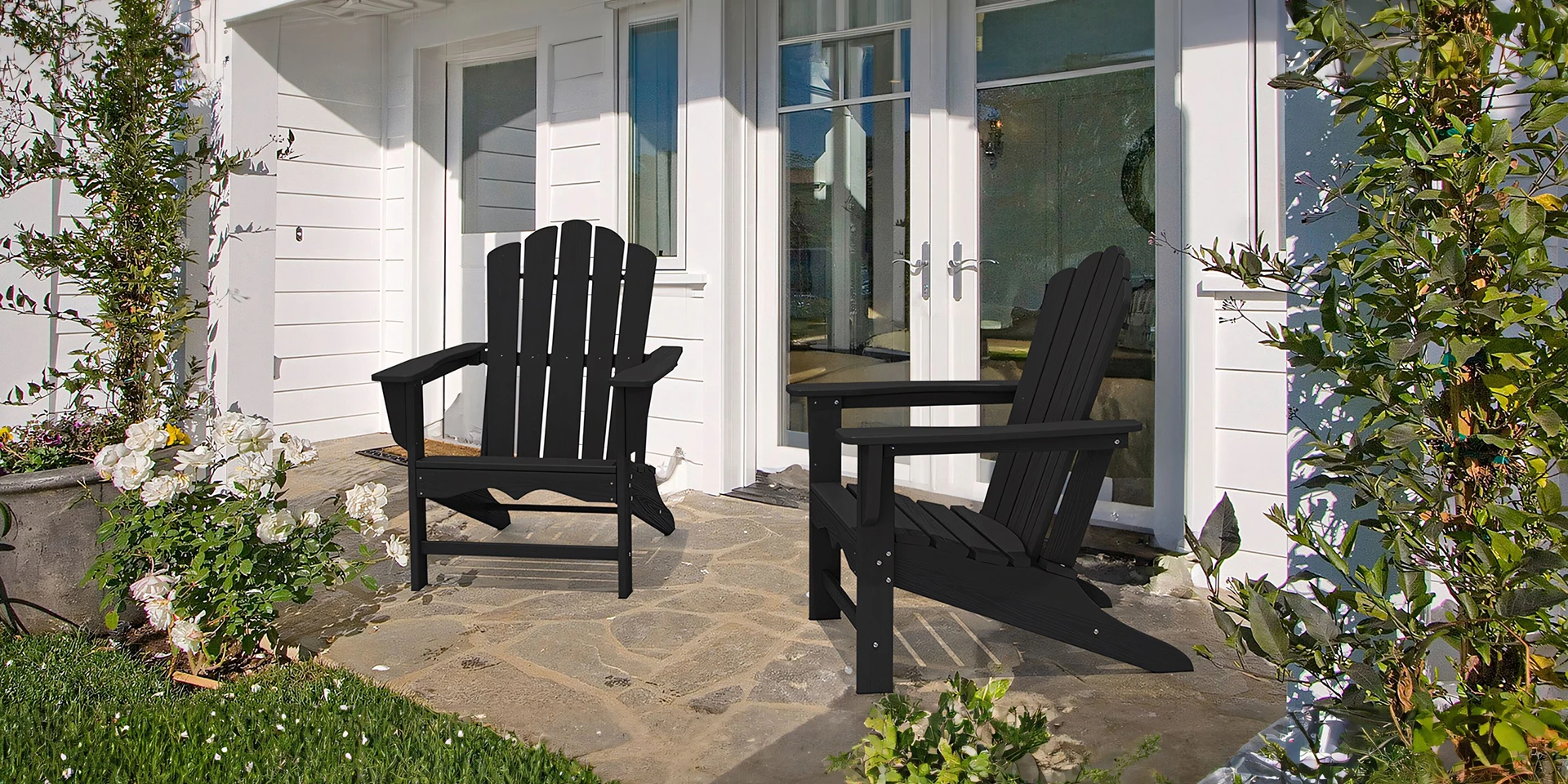 Two Black Vintage HDPE Poly Adirondack Chairs on the Front Porch