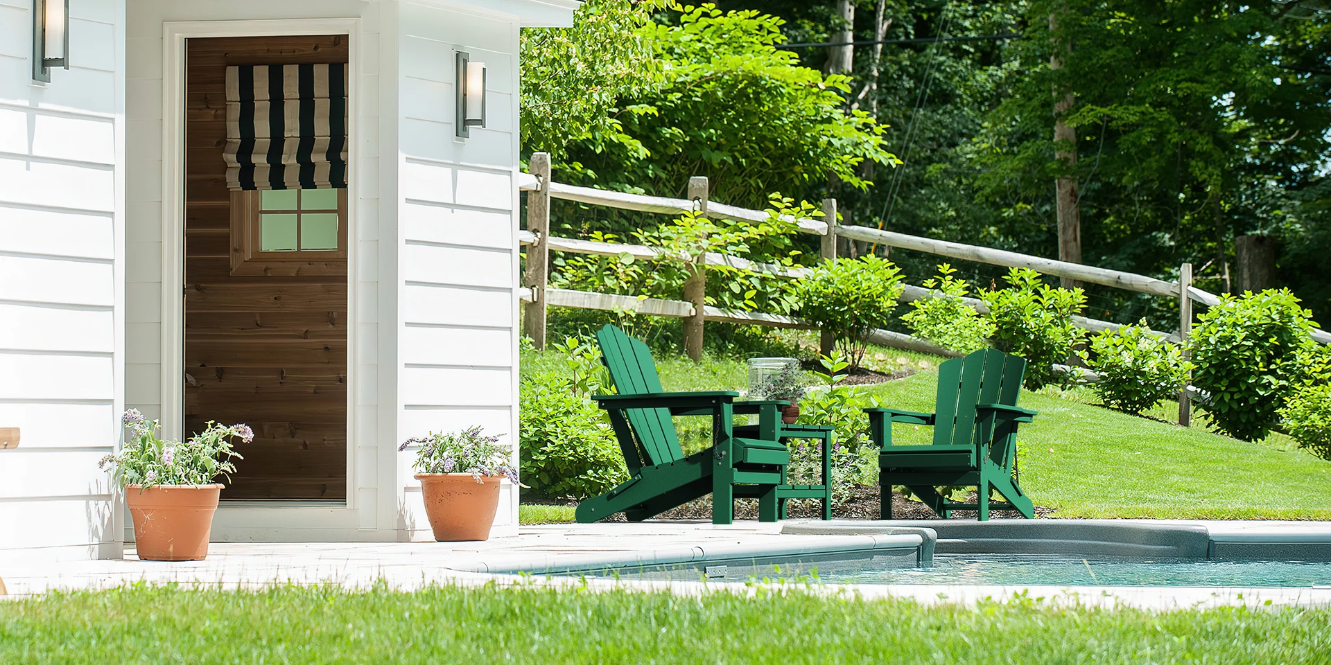 Two green vintage folding Adirondack chairs by the pool