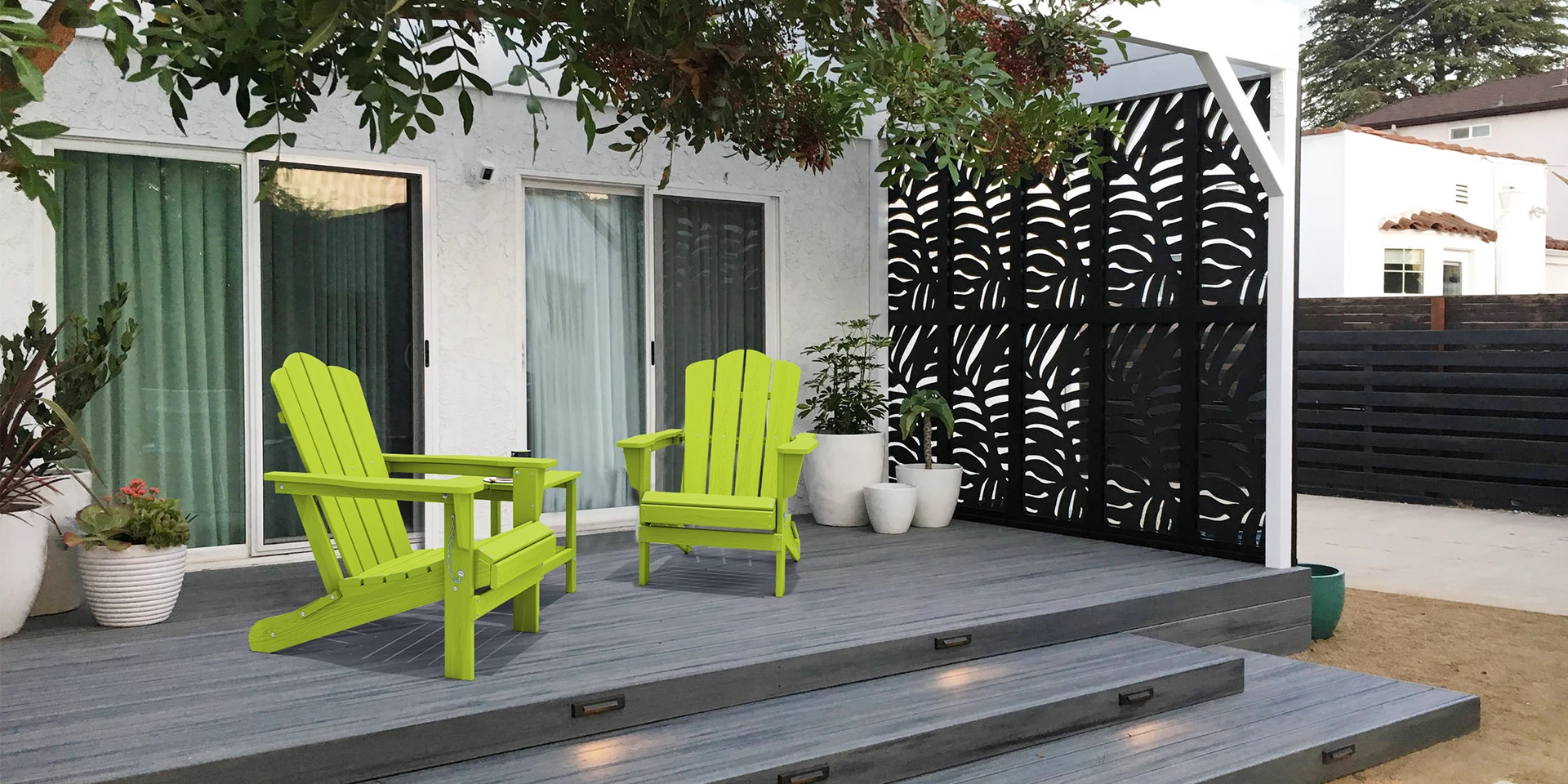 Two green vintage folding Adirondack chairs on patio deck