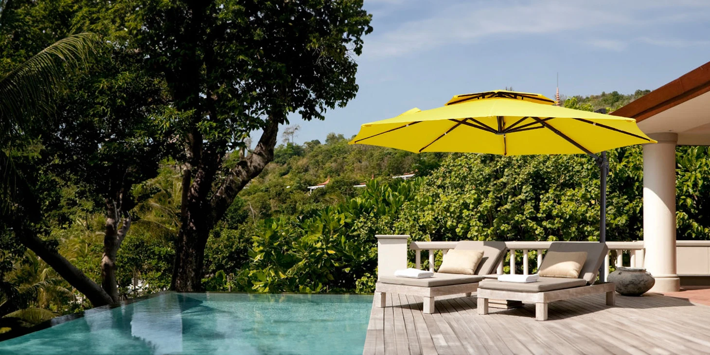 The yellow 10 ft cantilever umbrella placed by the pool