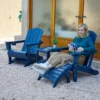 A woman reading on the HDPE 5-Piece Reclining Adirondack Chair Conversation Set-Navy Blue