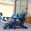 A woman relaxing on the HDPE 5-Piece Reclining Adirondack Chair Conversation Set-Navy Blue