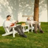A couple resting on the Vintage Folding Adirondack Chair with Reclining Backrest-White in the backyard