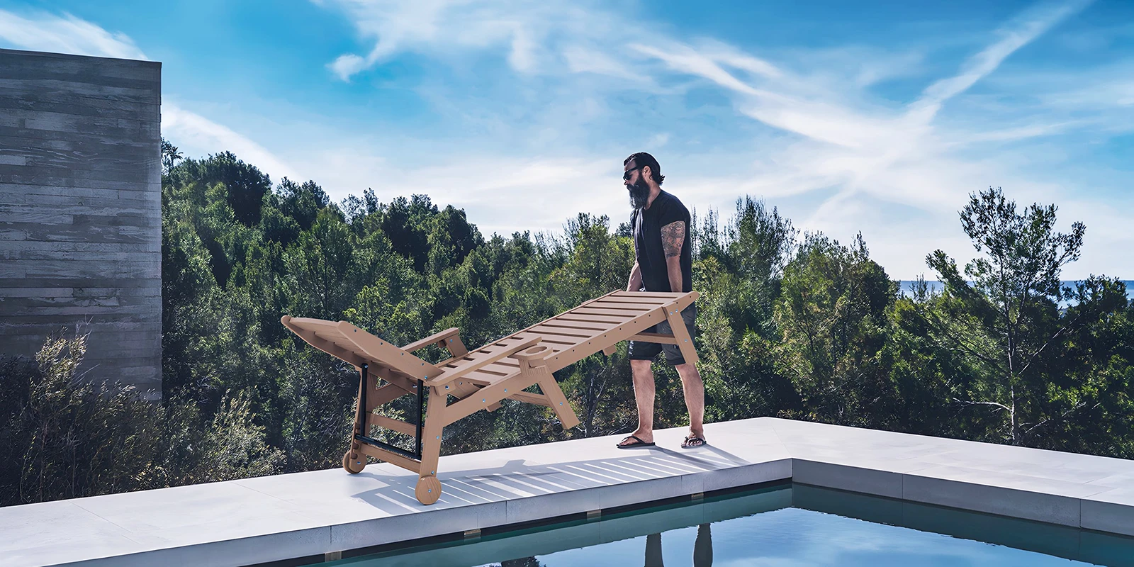 A man moving the chaise lounge with wheel