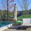 10ft Round Offset Hanging Umbrella with Base-Beige by the poolside
