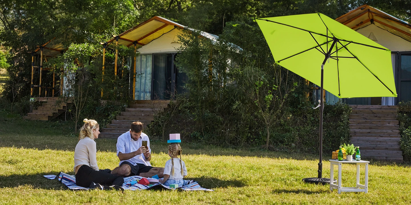 Family enjoy outdoor time with Round Tilt Patio Umbrella