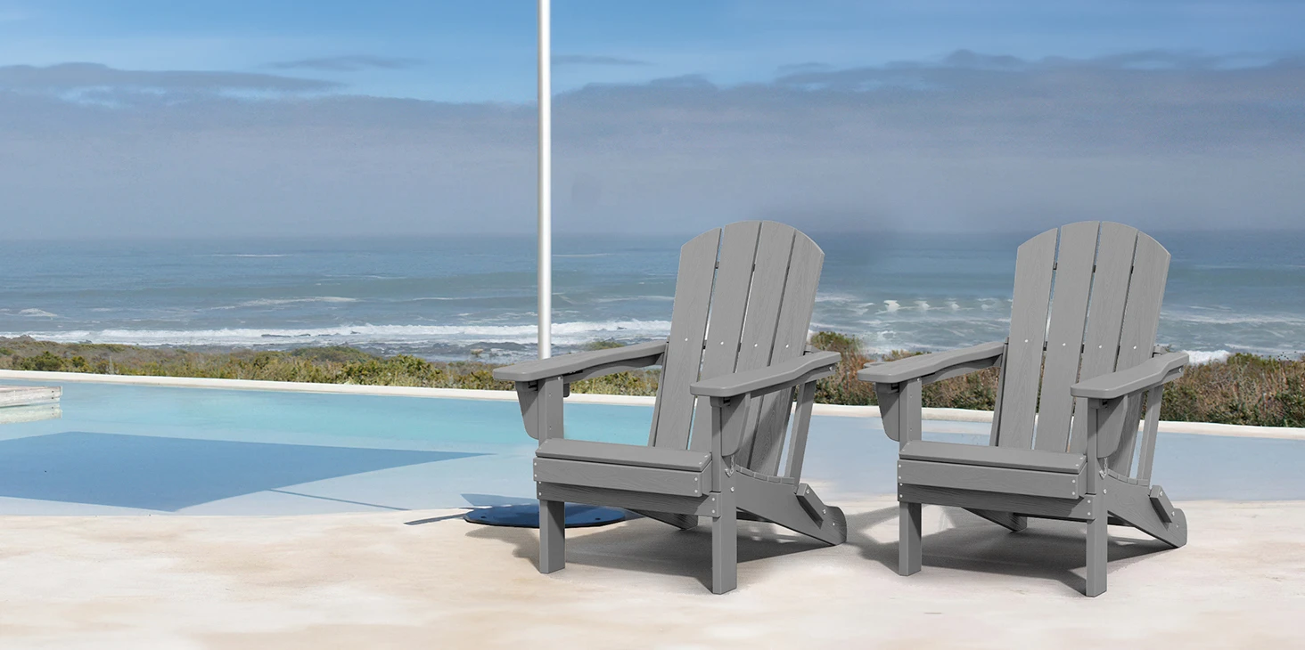 Two Dark Gray Reclining Folding Adirondack Chairs by the Pool