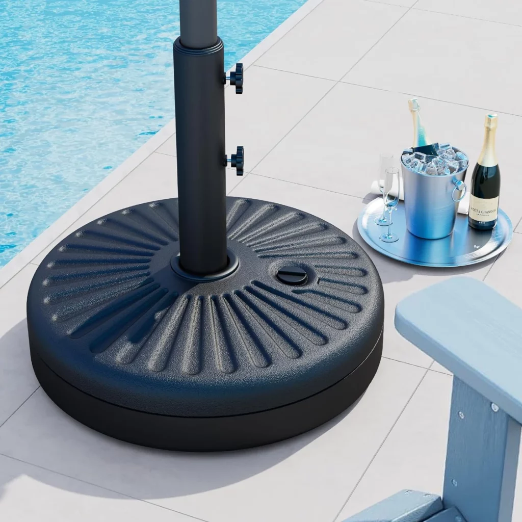 A portable umbrella stand and drinks are placed by the pool