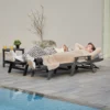 A couple lying on the HDPE Mesh Reclining Chaise Lounge with Wheels-Dark Gray