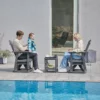 A family playing a board game on the Outdoor Adirondack Swivel Glider Chair