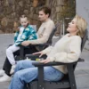 A family resting on the Outdoor Adirondack Swivel Glider Chair